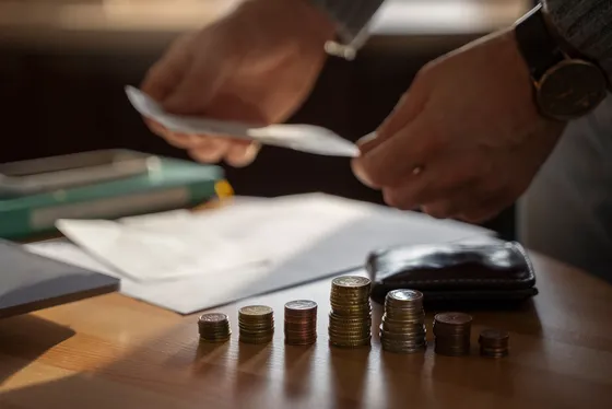 Counting coins and cash on a desk