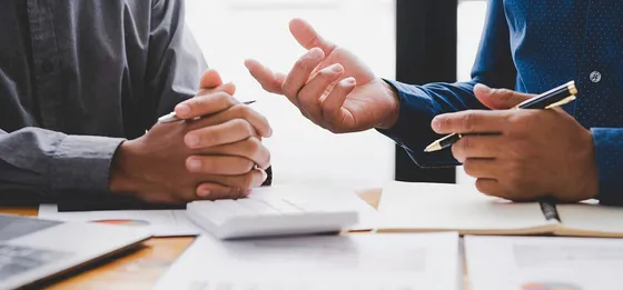 Two people discussing tax documents