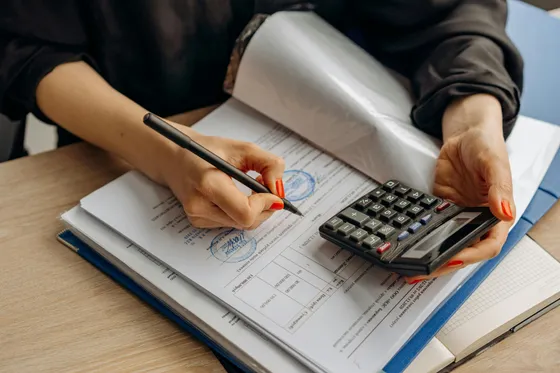 Reviewing tax documents with a calculator